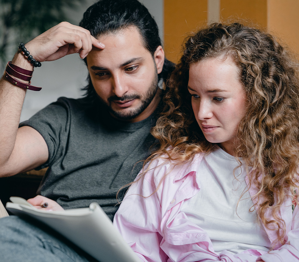 young couple reading a document
